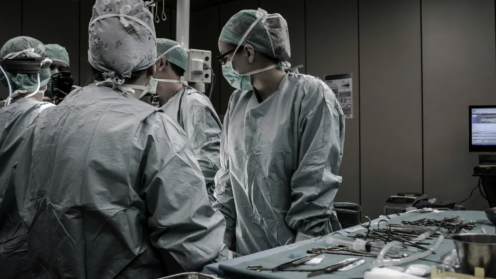 A surgical team at work around the table