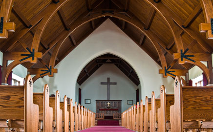 Church nave with cameras mounted on the timber arches